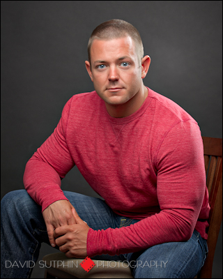 Portrait of Chuck sitting. Strong lighting used to contour Chuck's physique.