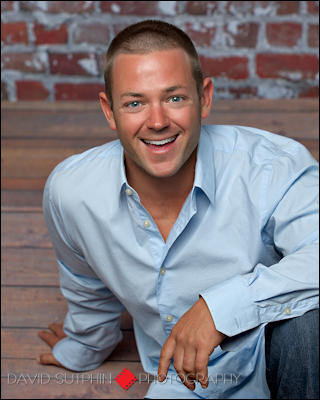 A very causal portrait of chuck sitting on the floor in the photography studio in a very relaxed pose.